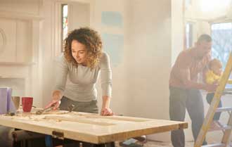 Woman carving wood door